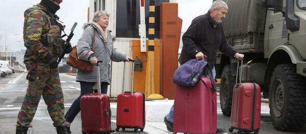 A Belgian soldier accompanies passengers at Brussels' Zaventem airport following Tuesday's bomb attacks in Brussels, Belgium, March 23, 2016. A Belgian soldier accompanies passengers at Brussels' Zaventem airport following Tuesday's bomb attacks in Brussels, Belgium, March 23, 2016. - Sputnik International