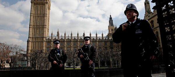 Armed British police officers stand on duty in front of the Elzabeth Tower, better known as Big Ben, outside the vehicle entrance to the Houses of Parliament in central London on March 22, 2016. Armed British police officers stand on duty in front of the Elzabeth Tower, better known as Big Ben, outside the vehicle entrance to the Houses of Parliament in central London on March 22, 2016. - Sputnik International