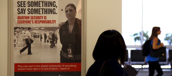 A poster regarding airport security hangs from a wall as passengers walk around the departures area at Sydney International Airport, Australia, March 23, 2016. A poster regarding airport security hangs from a wall as passengers walk around the departures area at Sydney International Airport, Australia, March 23, 2016. - Sputnik International