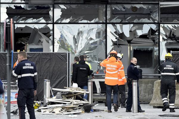 Broken windows of the terminal at Brussels national airport are seen during a ceremony following bomb attacks in Brussels metro and Belgium's National airport of Zaventem, Belgium, March 23, 2016 Broken windows of the terminal at Brussels national airport are seen during a ceremony following bomb attacks in Brussels metro and Belgium's National airport of Zaventem, Belgium, March 23, 2016 - Sputnik International