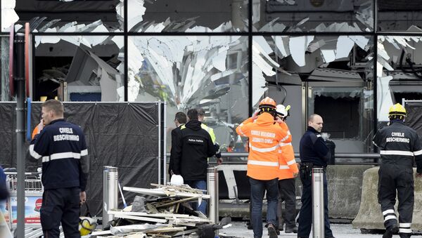 Broken windows of the terminal at Brussels national airport are seen during a ceremony following bomb attacks in Brussels metro and Belgium's National airport of Zaventem, Belgium, March 23, 2016 - Sputnik International