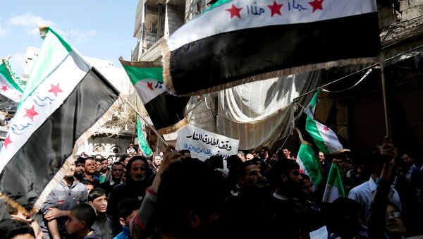 Syrian civilians and activists wave their national flags on the outskirts of the capital Damascus, on March 4, 2016. - Sputnik International
