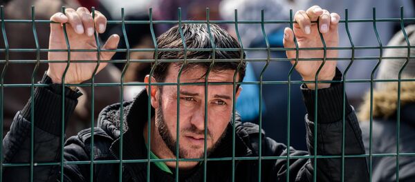A migrant waits at a Turkish coast guard station at the Dikili district in Izmir, on March 20, 2016 after being catched with other migrants while trying to reach the Greek island of Lesbos from the Bademli village, western Turkey. A migrant waits at a Turkish coast guard station at the Dikili district in Izmir, on March 20, 2016 after being catched with other migrants while trying to reach the Greek island of Lesbos from the Bademli village, western Turkey. - Sputnik International