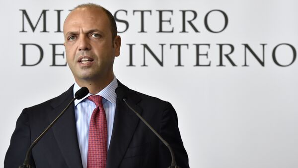 Italian Interior Minister Angelino Alfano speaks during a press conference after the departure of a group of Eritrean refugees from Italy to Sweden as part of a new programme of the European Union to relocate refugees on October 9, 2015 at the Ciampino airport of Rome - Sputnik International