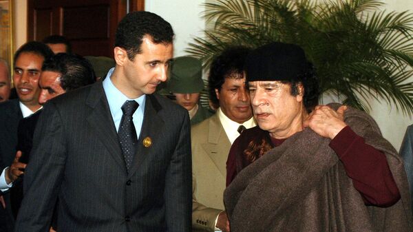 In this March 22, 2005 file photo, Syrian President Bashar Assad, left, talks to Libyan leader Moammar Gadhafi prior the 17th League of Arab States' summit in Algiers, Algeria.  - Sputnik International
