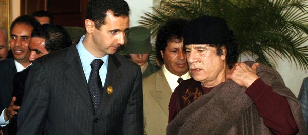 In this March 22, 2005 file photo, Syrian President Bashar Assad, left, talks to Libyan leader Moammar Gadhafi prior the 17th League of Arab States' summit in Algiers, Algeria. In this March 22, 2005 file photo, Syrian President Bashar Assad, left, talks to Libyan leader Moammar Gadhafi prior the 17th League of Arab States' summit in Algiers, Algeria. - Sputnik International