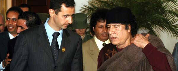 In this March 22, 2005 file photo, Syrian President Bashar Assad, left, talks to Libyan leader Moammar Gadhafi prior the 17th League of Arab States' summit in Algiers, Algeria. In this March 22, 2005 file photo, Syrian President Bashar Assad, left, talks to Libyan leader Moammar Gadhafi prior the 17th League of Arab States' summit in Algiers, Algeria. - Sputnik International