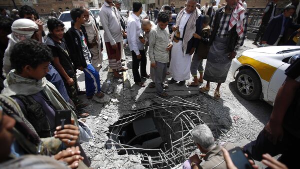 People stand around damages made by a Saudi-led airstrike on a bridge in Sanaa, Yemen, Wednesday, March 23, 2016. Yemen has been left fragmented by war pitting Shiite Houthi rebels and military units loyal to a former president against a US-backed, Saudi-led coalition supporting the internationally recognized government. - Sputnik International