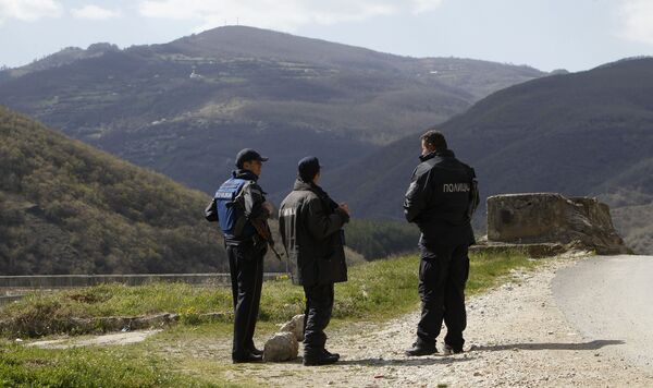 Police officers look towards the Macedonian mountain village of Gosince from a police check point set near the northern Macedonian border with Kosovo. file photo Police officers look towards the Macedonian mountain village of Gosince from a police check point set near the northern Macedonian border with Kosovo. file photo - Sputnik International