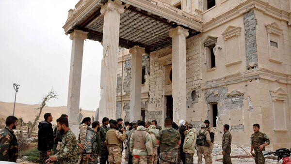 Forces loyal to Syria's President Bashar al-Assad gather at a palace complex on the western edge of Palmyra in this picture provided by SANA on March 24, 2016. - Sputnik International