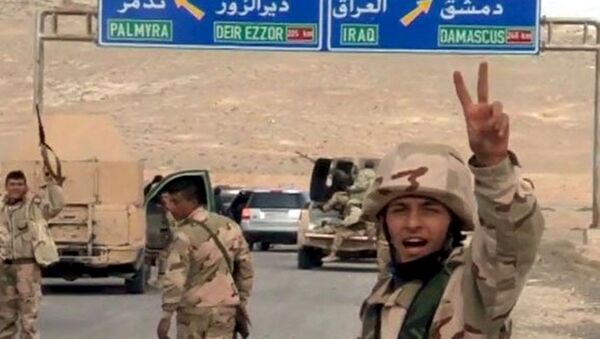 Forces loyal to Syria's President Bashar al-Assad gesture as they advance into the historic city of Palmyra in this picture provided by SANA on March 24, 2016. - Sputnik International