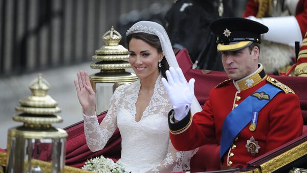 Britain's Prince William and his wife Kate, Duchess of Cambridge, wave as they travel in the 1902 State Landau carriage along the Processional Route to Buckingham Palace, in London, on April 29, 2011 - Sputnik International