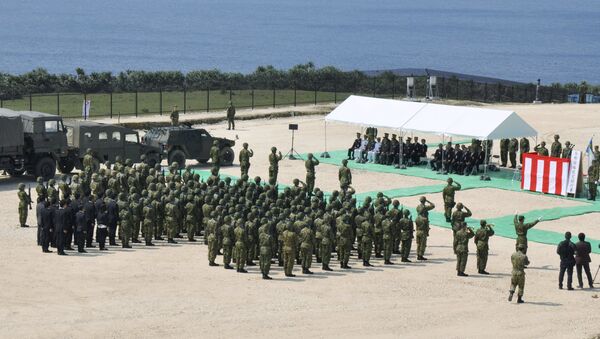 Members of Japan's Self Defence Force hold an opening ceremony of a new military base on the island of Yonaguni in the Okinawa prefecture, March 28, 2016. - Sputnik International