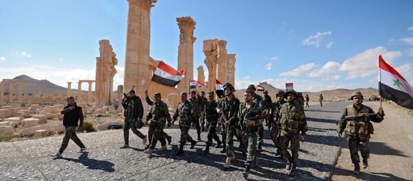 Liberation of Palmyra: Syrian soldiers with the flag of Syria are marching through Palmyra. Liberation of Palmyra: Syrian soldiers with the flag of Syria are marching through Palmyra. - Sputnik International
