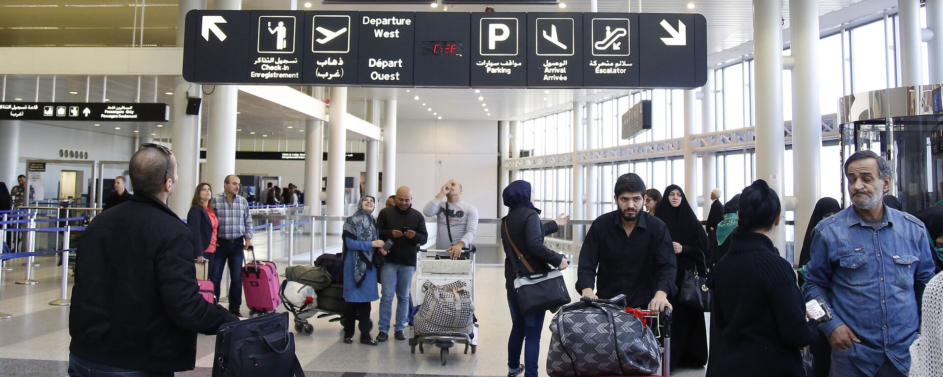 Travelers check the flight schedule screens for delays or cancellations, at the departure terminal of Rafik Hariri international airport in the Lebanese capital, Beirut, on November 21, 2015 - Sputnik International, 1920, 19.09.2024