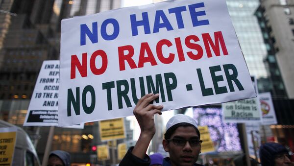 A Muslim youth holds a poster during a protest against Donald Trump on December 20, 2015 in New York - Sputnik International
