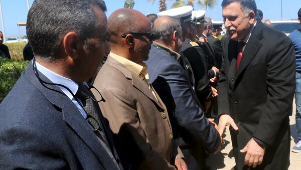 Libyan Prime Minister-designate Fayez Seraj (R) is greeted upon arrival in Tripoli, Libya March 30, 2016 - Sputnik International