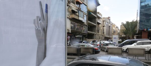 Syrians drive past a billboard for the upcoming parliamentary elections in the capital Damascus on March 15, 2016 - Sputnik International