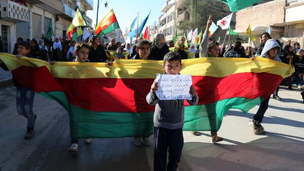 Kurdish children hold a flag of the Kurdish People's Protection Units (YPG) political wing, the Democratic Union Party (PYD), and banners during a demonstration against the exclusion of Syrian-Kurds from the Geneva talks in the northeastern Syrian city of Qamishli on February 4, 2016 - Sputnik International