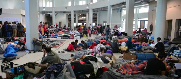Migrants and refugees rest at the passengers terminal at the port of Piraeus where more than 5,500 migrants and refugees have found temporary shelter on March 30, 2016 Migrants and refugees rest at the passengers terminal at the port of Piraeus where more than 5,500 migrants and refugees have found temporary shelter on March 30, 2016 - Sputnik International