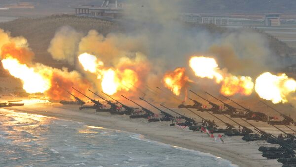 Artillery pieces are seen being fired during a military drill at an unknown location, in this undated photo released by North Korea's Korean Central News Agency (KCNA) on March 25, 2016 - Sputnik International