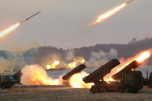 Multiple rocket launchers are seen being fired during a military drill at an unknown location, in this undated photo released by North Korea's Korean Central News Agency (KCNA) on March 25, 2016 - Sputnik International