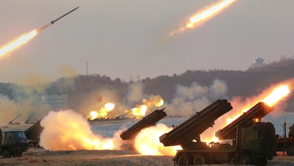 Multiple rocket launchers are seen being fired during a military drill at an unknown location, in this undated photo released by North Korea's Korean Central News Agency (KCNA) on March 25, 2016 - Sputnik International