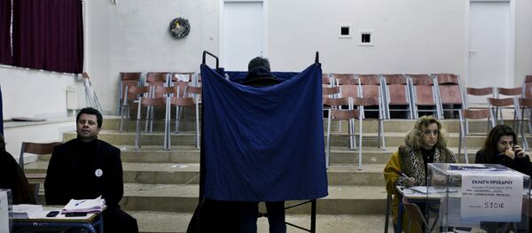 A man prepares his vote in a voting booth prior to casting his ballot in an election for the leadership of Greece's conservative New Democracy party, at a polling station in Athens (File) - Sputnik International