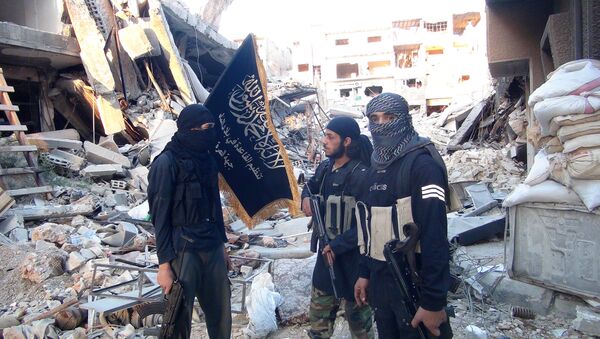 Fighters from the al-Qaida group in the Levant, Al-Nusra Front, stand among destroyed buildings near the front line with Syrian government solders in Yarmuk Palestinian refugee camp, south of Damascus on September 22, 2014 - Sputnik International