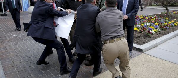 urkish security personnel struggle to take a sign away from protesters in front of the Brookings Institute before the arrival of Turkish President Recep Tayyip Erdogan in Washington. urkish security personnel struggle to take a sign away from protesters in front of the Brookings Institute before the arrival of Turkish President Recep Tayyip Erdogan in Washington. - Sputnik International