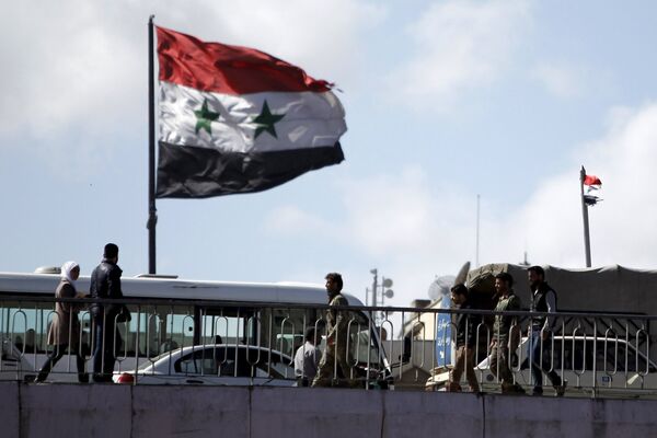 People walk near a Syrian national flag at the President bridge in Damascus, Syria March 14, 2016 People walk near a Syrian national flag at the President bridge in Damascus, Syria March 14, 2016 - Sputnik International