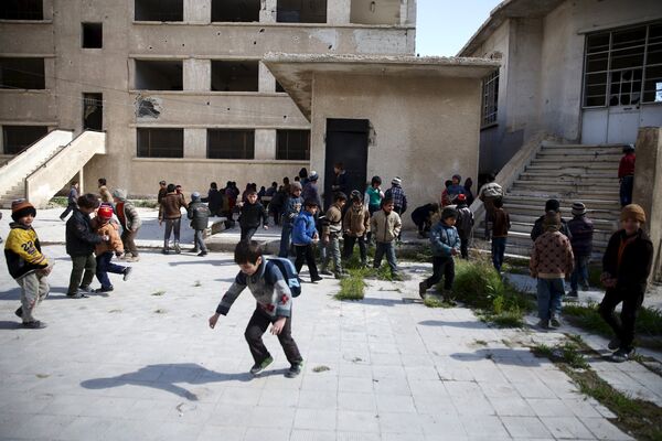 School children clean the courtyard of their school in the rebel held Douma neighborhood of Damascus, Syria, March 29, 2016 School children clean the courtyard of their school in the rebel held Douma neighborhood of Damascus, Syria, March 29, 2016 - Sputnik International