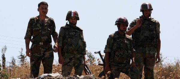 Syrian soldiers stand guard near a mass grave (File) Syrian soldiers stand guard near a mass grave (File) - Sputnik International