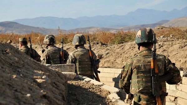 Armenian soldiers of the self-proclaimed republic of Nagorno-Karabagh walk in trenches at the frontline on the border with Azerbaijan, on October 25, 2012. - Sputnik International
