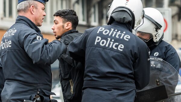 Policemen detain a man in the Molenbeek neighborhood in Brussels, Belgium - Sputnik International