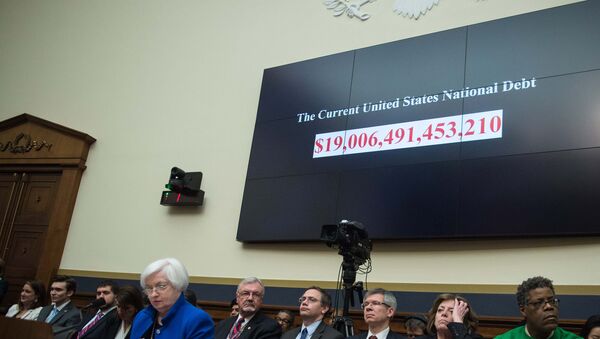 A screen shows the US national debt before US Federal Reserve chair Janet Yellen (front L) testifies before the House Financial Services Committee on Capitol Hill in Washington, DC, on February 10, 2016. - Sputnik International