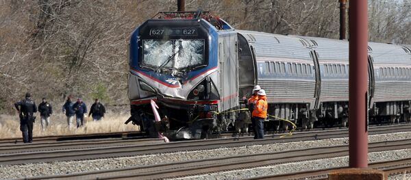 Emergency personnel examine the scene after an Amtrak passenger train struck a backhoe, killing two people, in Chester, Pennsylvania Emergency personnel examine the scene after an Amtrak passenger train struck a backhoe, killing two people, in Chester, Pennsylvania - Sputnik International
