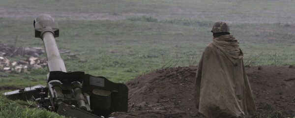 An Armenian soldier of the self-defense army of Nagorno-Karabakh stands near an artillery unit in the town of Martakert, where clashes with Azeri forces are taking place, in Nagorno-Karabakh region An Armenian soldier of the self-defense army of Nagorno-Karabakh stands near an artillery unit in the town of Martakert, where clashes with Azeri forces are taking place, in Nagorno-Karabakh region - Sputnik International