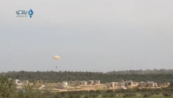 A pilot parachutes from a plane that was shot down, in this still image taken from video footage said to be shot in Al Eiss, Aleppo province, Syria, and uploaded to a social media website on April 5, 2016. - Sputnik International
