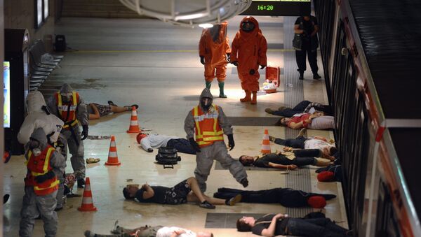 People are assisted by rescue workers during a chemical terrorist attack drill in the subway, during the EU URBAN CREATS 2013 community exercises in Lyon. (File) - Sputnik International
