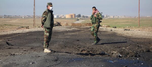 Kurdish soldiers survey the site of a bomb attack on a road between Mosul, Iraq, and the Syrian border in northern Iraq (File) - Sputnik International