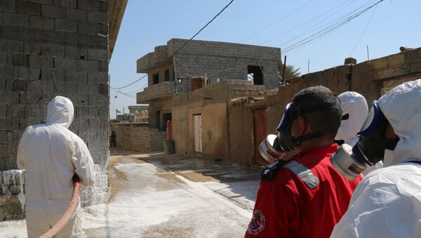 Members of the civil defence spray and clean areas in the town of Taza, around 220 kilometres north of the capital Baghdad, on March 13, 2016, that might have been contaminated in a chemical attack carried out by the Islamic State (IS) group the previous week - Sputnik International