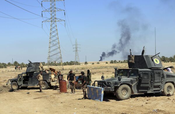 Smoke rises from Daesh positions after a US-led coalition airstrike as Iraqi Security forces surround the town of Hit, 85 miles (140 kilometers) west of Baghdad, Iraq. file photo Smoke rises from Daesh positions after a US-led coalition airstrike as Iraqi Security forces surround the town of Hit, 85 miles (140 kilometers) west of Baghdad, Iraq. file photo - Sputnik International