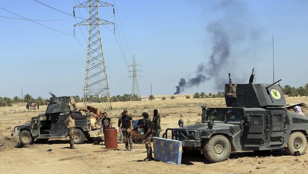 Smoke rises from Daesh positions after a US-led coalition airstrike as Iraqi Security forces surround the town of Hit, 85 miles (140 kilometers) west of Baghdad, Iraq. file photo - Sputnik International