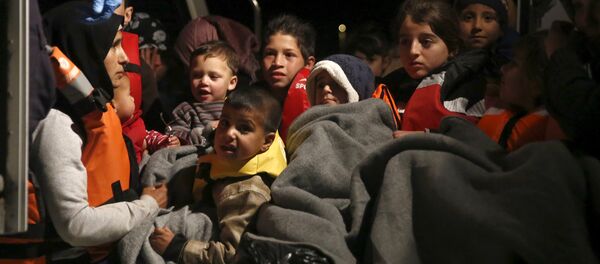 Refugee children are seen onboard a Greek Coast Guard vessel, carrying other refugees and migrants, as it arrives at the port of Mytilene on the Greek island of Lesbos, following a rescue operation at open sea, April 5, 2016 Refugee children are seen onboard a Greek Coast Guard vessel, carrying other refugees and migrants, as it arrives at the port of Mytilene on the Greek island of Lesbos, following a rescue operation at open sea, April 5, 2016 - Sputnik International