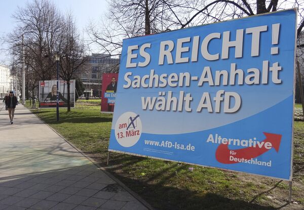 A man walks past a campaign poster of right-populist AfD party reading It's enough - Saxony-Anhalt elects AfD in Magdeburg, Germany. A man walks past a campaign poster of right-populist AfD party reading It's enough - Saxony-Anhalt elects AfD in Magdeburg, Germany. - Sputnik International