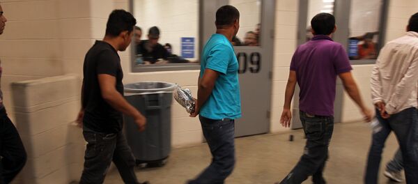 Immigrants who have been caught crossing the border illegally are housed inside the McAllen Border Patrol Station in McAllen, Texas, where they are processed on July 15, 2014 - Sputnik International