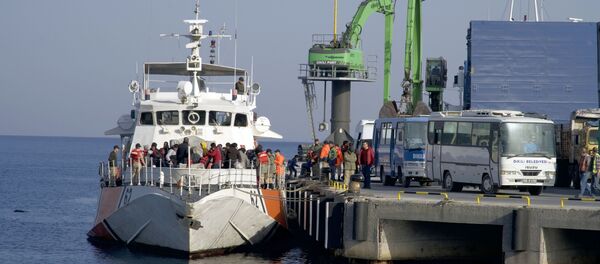 Migrants disembark after they were apprehended by the Turkish coast guard on the Aegean Sea between Turkey and Greece, in Dikili port, Turkey, Wednesday, April 6, 2016 Migrants disembark after they were apprehended by the Turkish coast guard on the Aegean Sea between Turkey and Greece, in Dikili port, Turkey, Wednesday, April 6, 2016 - Sputnik International