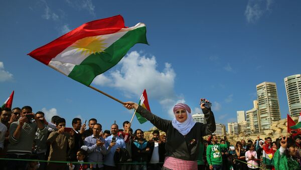 Syrian Kurd Nazdan who fled her home in Qamishli, Syria, wears traditional clothes as she dances and waves a Kurdish flag, during a celebration of Nowruz day, in Beirut, Lebanon, Monday, March 21, 2016 - Sputnik International