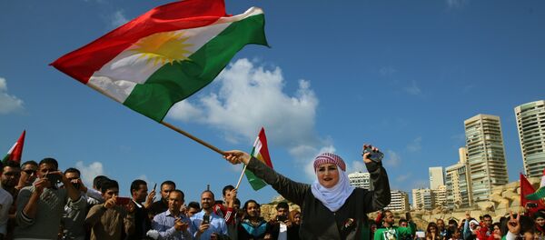 Syrian Kurd Nazdan who fled her home in Qamishli, Syria, wears traditional clothes as she dances and waves a Kurdish flag, during a celebration of Nowruz day, in Beirut, Lebanon, Monday, March 21, 2016 Syrian Kurd Nazdan who fled her home in Qamishli, Syria, wears traditional clothes as she dances and waves a Kurdish flag, during a celebration of Nowruz day, in Beirut, Lebanon, Monday, March 21, 2016 - Sputnik International